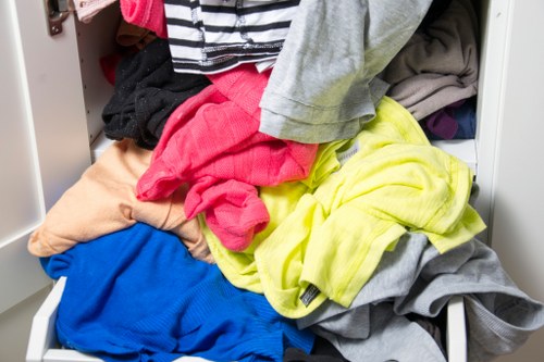 Close-up of garden clearance worker removing brambles with gloves and tools